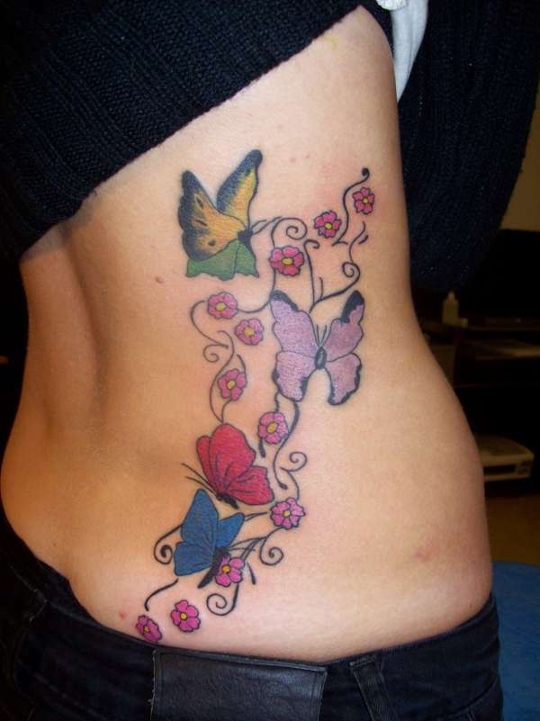 awesome rib tattoos for girls,rib cage tattoo designs for girls,butterfly rib cage tattoos,beautiful rib cage tattoo designs for girls